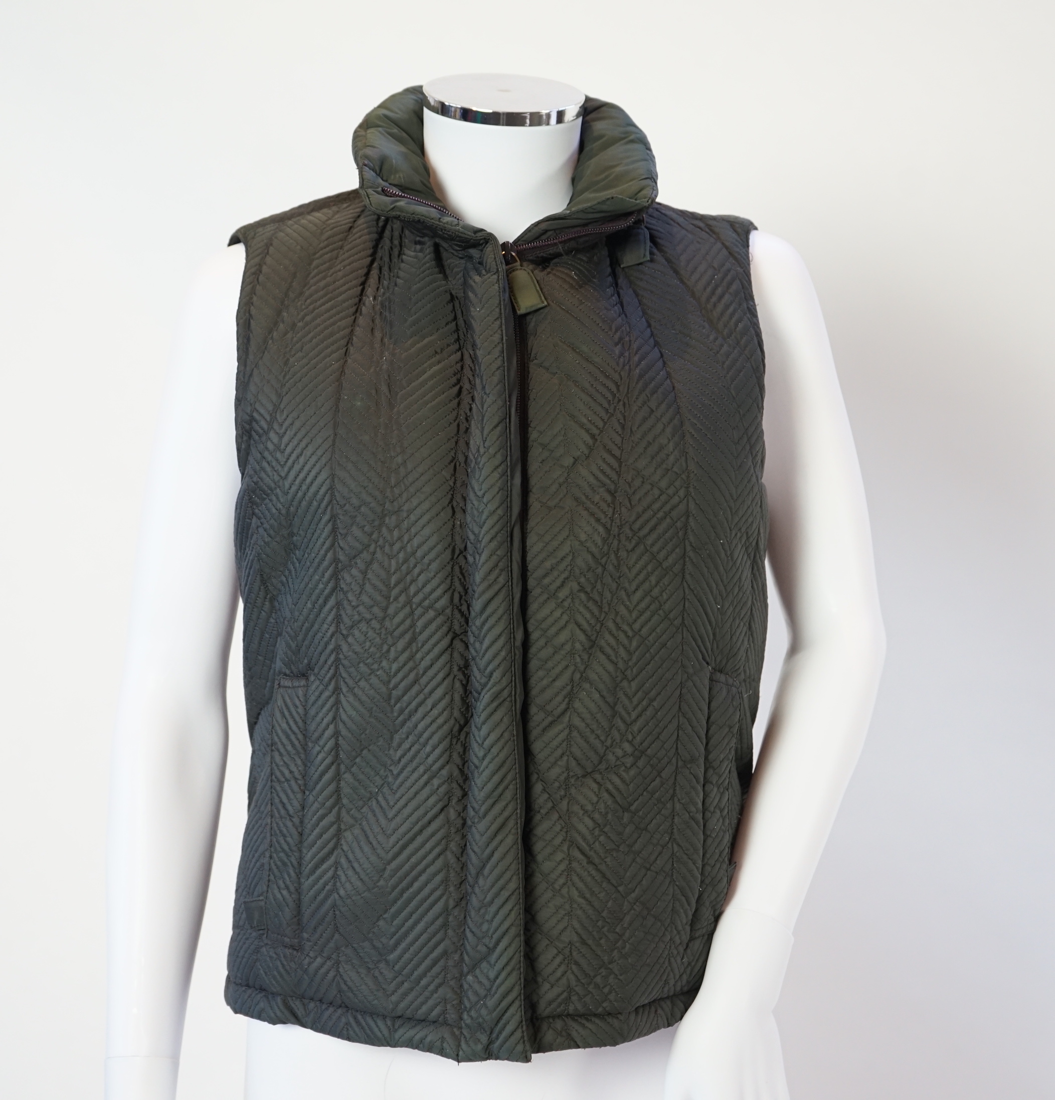 A Prada quilted olive green and brown lady's gilet with hood in collar, size M